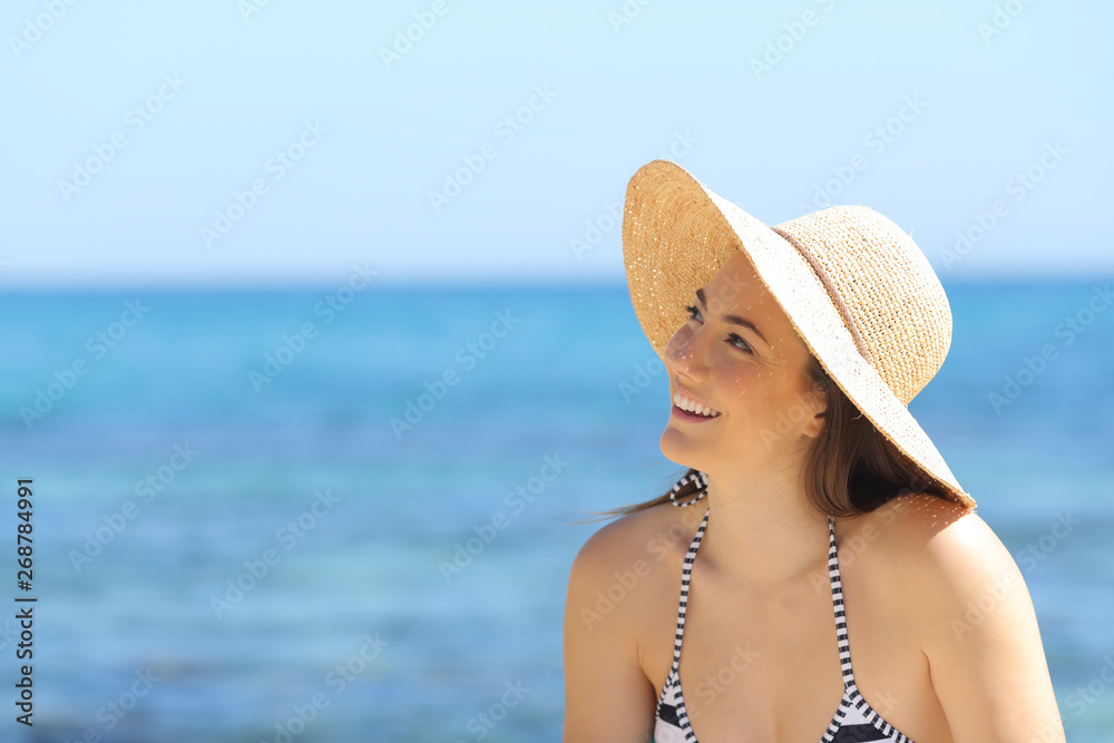 Sunbather dreaming looking at side on the beach