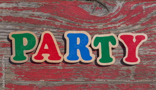 word party made of wooden letters on shabby wood background