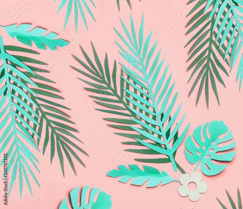 Turquoise green tropical leaves on pastel pink background, top view, flat lay. Creative botanical layout