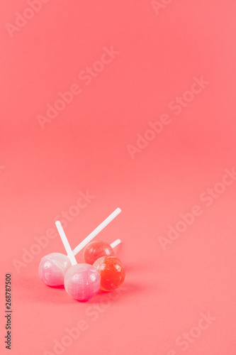 Lollipops on the corner of the coral background