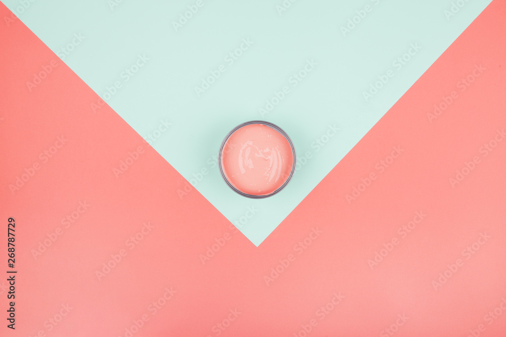 An elevated view of paint can on mint and coral background An elevated view of paint can on mint and coral background