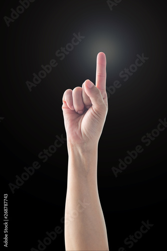 Pointing finger woman's hand with rim light isolated on black background (clipping path) for number one 1, showing direction, go straight forward, good ides