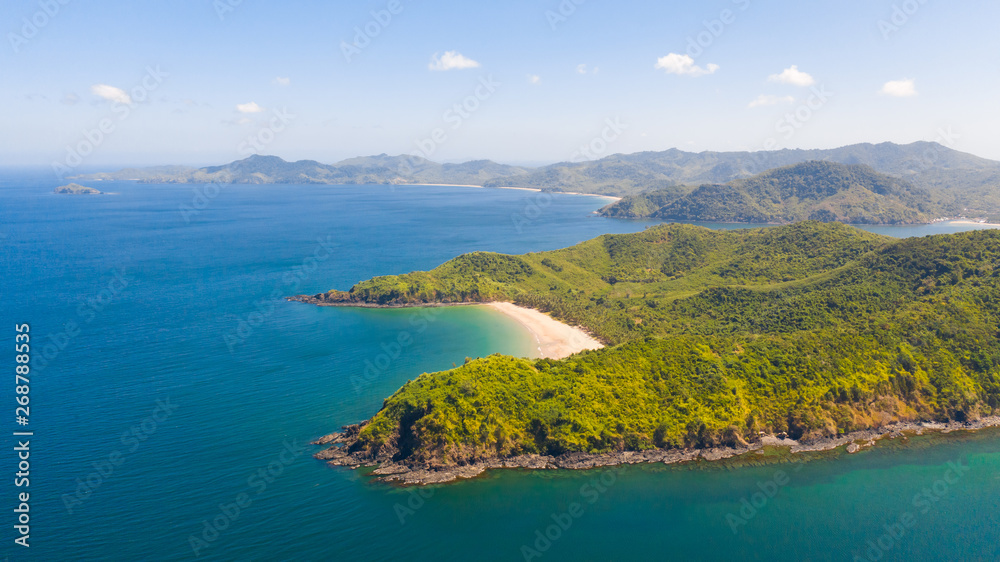 aerial view island with tropical sandy beach and palm trees. Malajon Island, Philippines, Palawan. tourist boats on coast tropical island. Summer and travel vacation concept. beach and blue clear sea