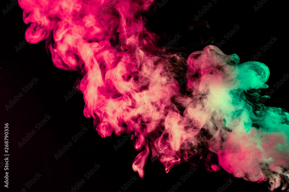 Beautiful column of smoke in the neon bright light of red, green, pink and turquoise on a black background exhaled out of the vape. Nice pattern for printing and backdrop of colored waves.