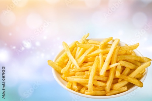 Plate of french fries on wooden table