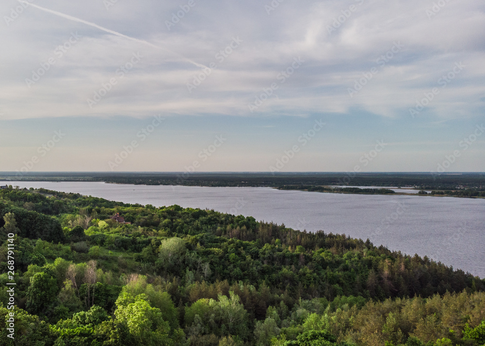 Green hills with forest near large river Green hills with forest near large river