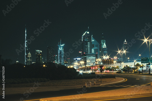 Night landscape with views of the skyscrapers and the Burj Khalifa from the side of the road © volhavasilevich