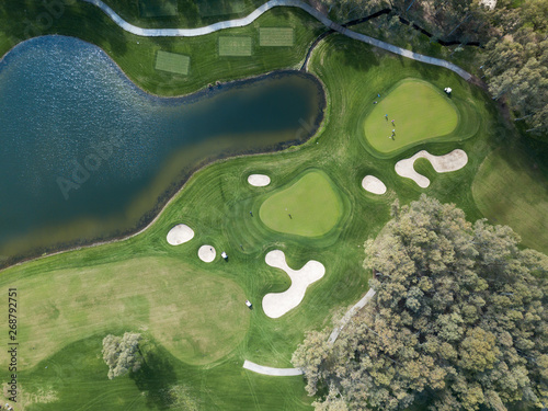 Aerial photo of green golf fields in spring