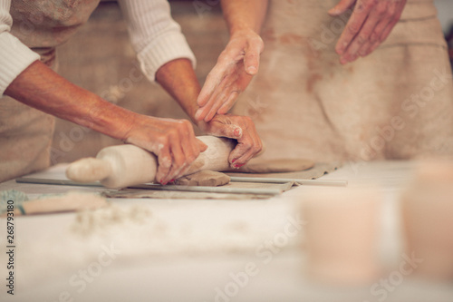 Close up of female hands holding a rolling pin