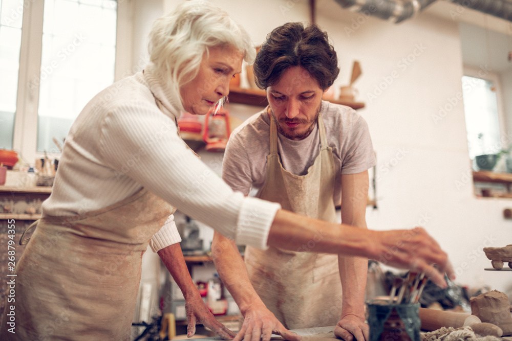 Fototapeta premium Serious skilled man and woman focusing on work