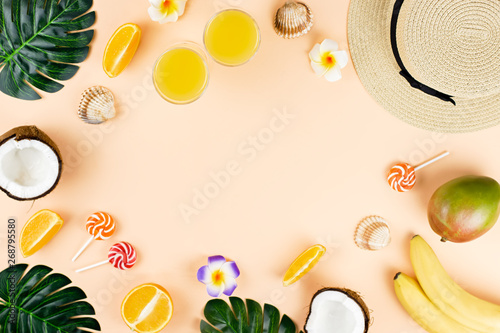 Summer tropical fruits frame on coral color background