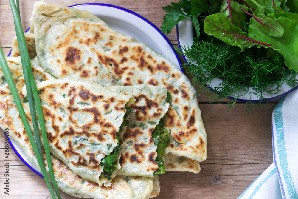 Baker making traditional dish of Armenians from Artsakh Zhingyalov hats is a type of flatbread stuffed with herbs.