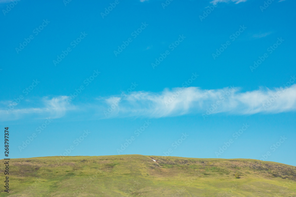 picturesque hill against the blue sky. Serenity