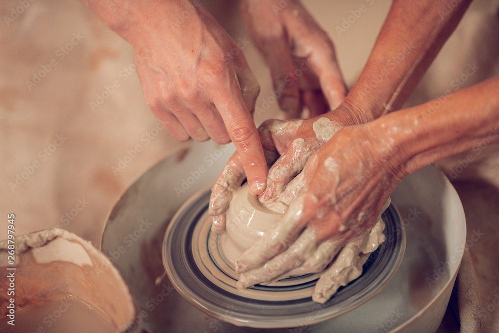 Top view of artists hands making pots