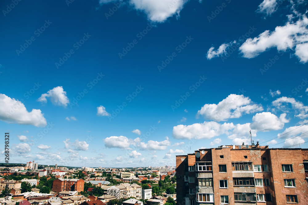 high-rise residential building in eastern europe. blue sky over the city. residential building. shabby high-rise building.