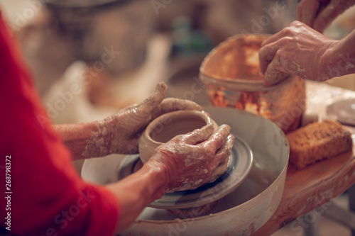 Close up of female hands molding the pot photo