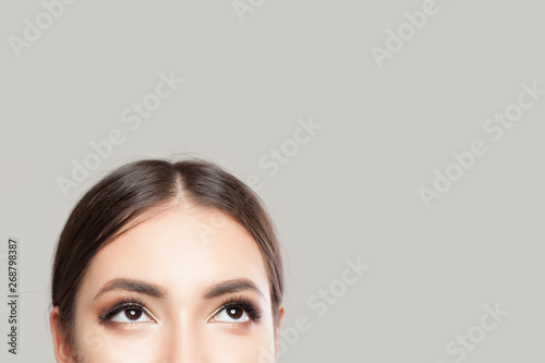Perfect female eyes looking up on white background