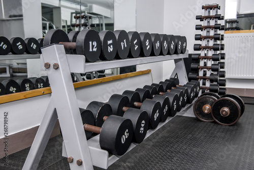 Dumbells in gym, sportive equipment close up