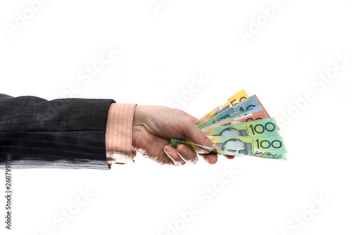 Male hand holding and offering australian dollar banknotes