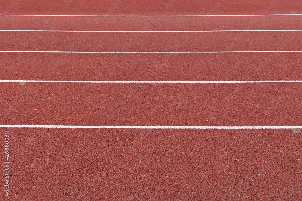 Horizontal red running track with white lines marking the lanes 