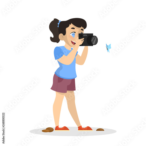 Little girl with camera shooting beautiful butterfly
