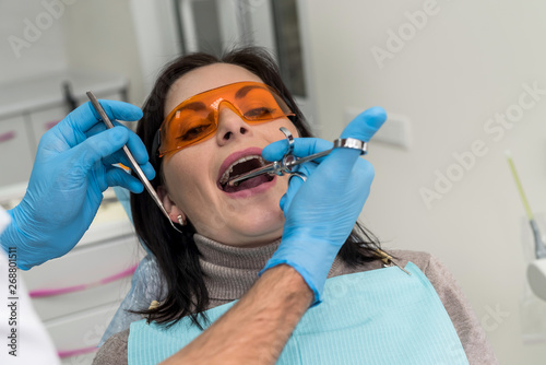 Dentist making injection of anesthetic to patient