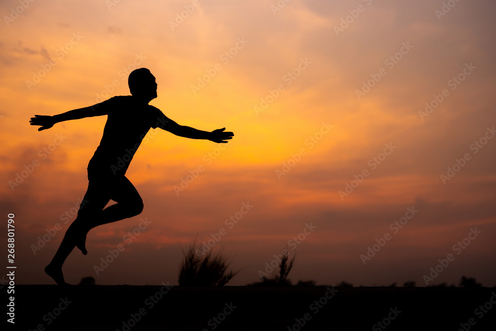 Man running alone at beautiful sunset in the road at park . Summer sport and freedom concept. Athlete training on dusk. - Image Man running alone at beautiful sunset in the road at park . Summer sport and freedom concept. Athlete training on dusk. - Image