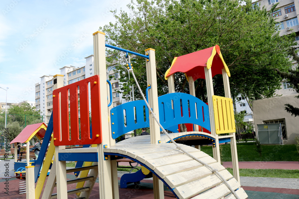 Colorful children playground activities in the yard. Urban neighborhood childhood concept 