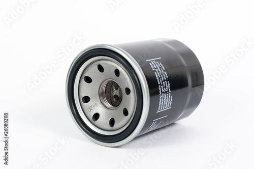Close up new oil filter engine car isolated on white background studio, copy space