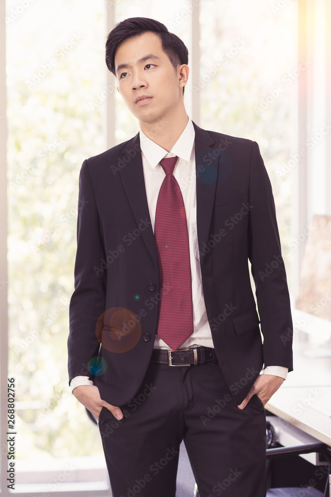 Asian Businessman standing and posing in office.. Asian Businessman standing and posing in office..
