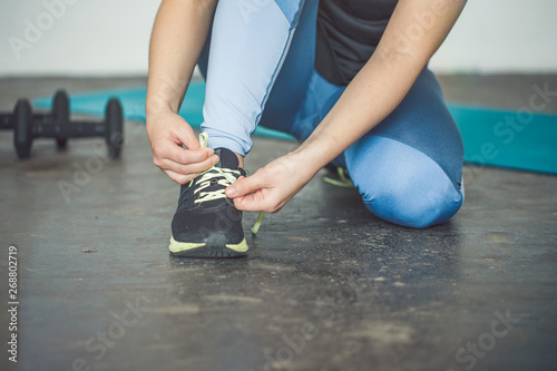 Young woman Lace up shoes for the workout of her life