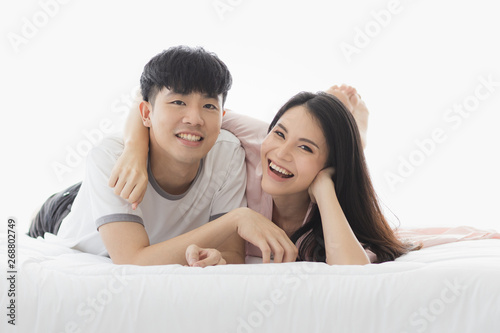Asian couple spending time together on the bed..