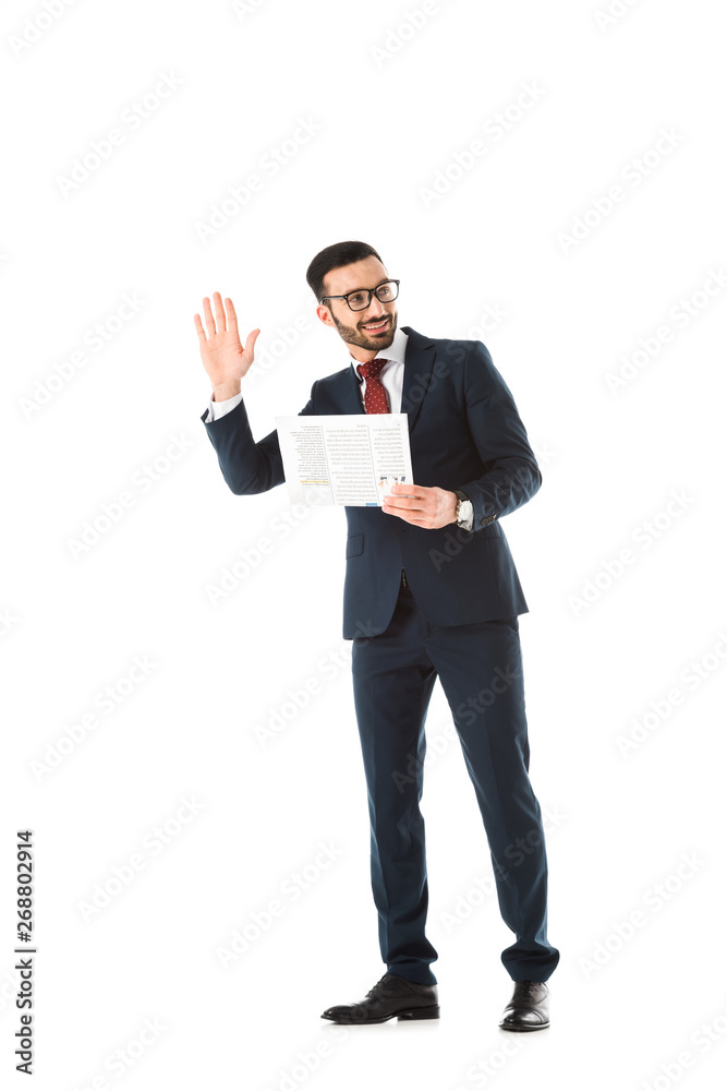 smiling businessman with newspaper looking back and showing hello gesture isolated on white smiling businessman with newspaper looking back and showing hello gesture isolated on white