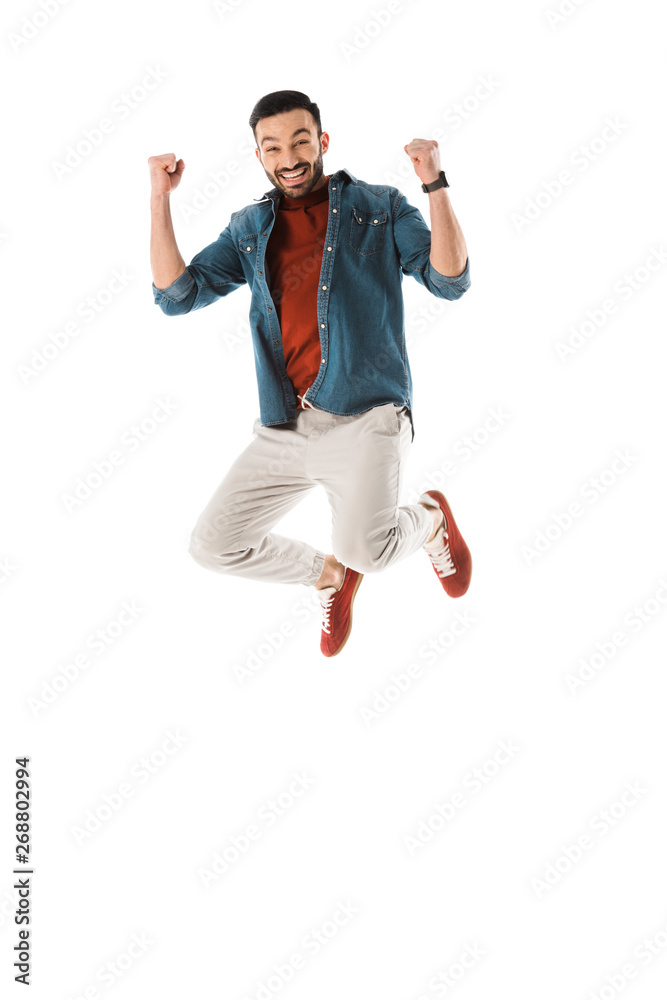 happy man jumping and showing winner gesture isolated on white happy man jumping and showing winner gesture isolated on white