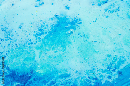 Abstract art texture background. Marbled surface design. Beautiful sky blue acrylic paint with splash effect.