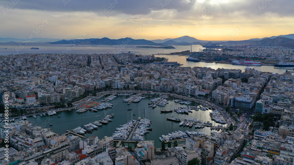 Aerial drone bird's eye view of famous port of Piraeus one of the largest in Europe at sunset with beautiful golden colours, Attica, Greece