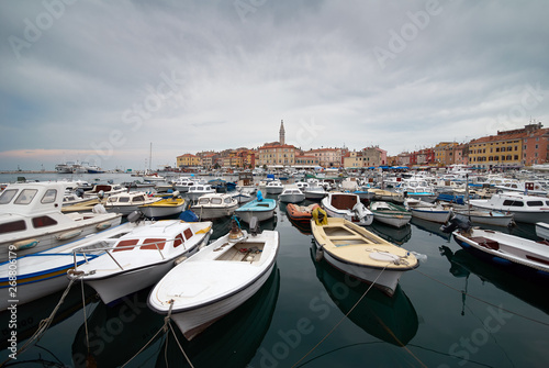 Rovinj, Croatia. Motorboats and boats on water in port of Rovinj. Medieval vintage houses of old town. Yachts landing, tower with clock on the background. © Brunbjorn