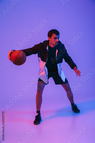 Portrait of a fit sportsman playing basketball