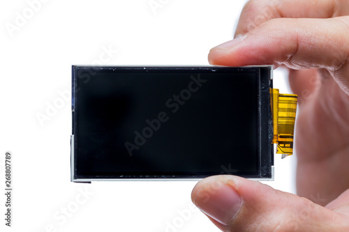 lcd screen digital display device electornic part disassembled on hand isolated on white photo