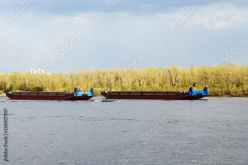 fishing boats on the river. transport barges on the river. photo