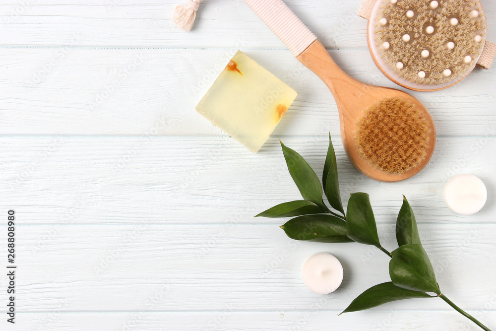Brush for massage in the spa composition on a colored background top view. Prevention of cellulite skin care. Flatlay Brush for massage in the spa composition on a colored background top view. Prevention of cellulite skin care. Flatlay