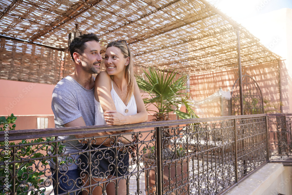 Couple at roof top of riad hotel enjoying scenery Couple at roof top of riad hotel enjoying scenery