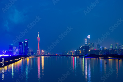 Guangzhou cityscape over the Pearl River with Liede Bridge, Canton TV Tower and financial district illuminated in the evening. Guangzhou, Southern China.