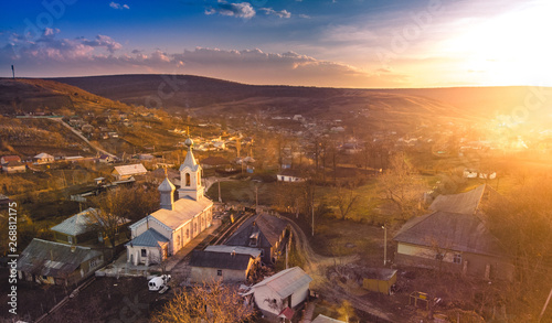 the beautiful church at sunset in a small village in Moldova. Aerial view