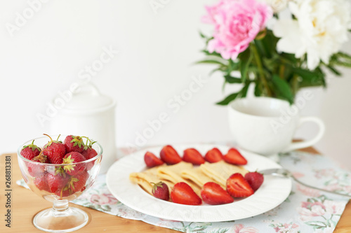 Wallpaper Mural pancakes with strawberries and coffee on the table near a vase with peonies on a white background Torontodigital.ca