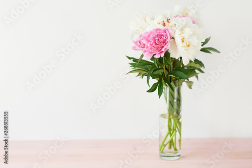 peonies in a vase on a white background