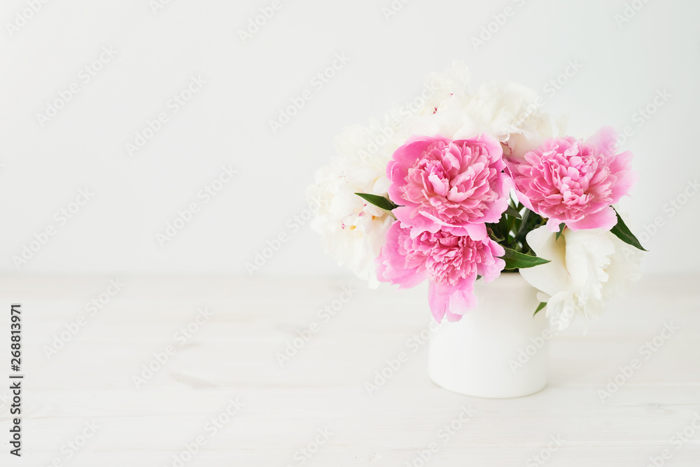 peonies in a vase on a white background peonies in a vase on a white background