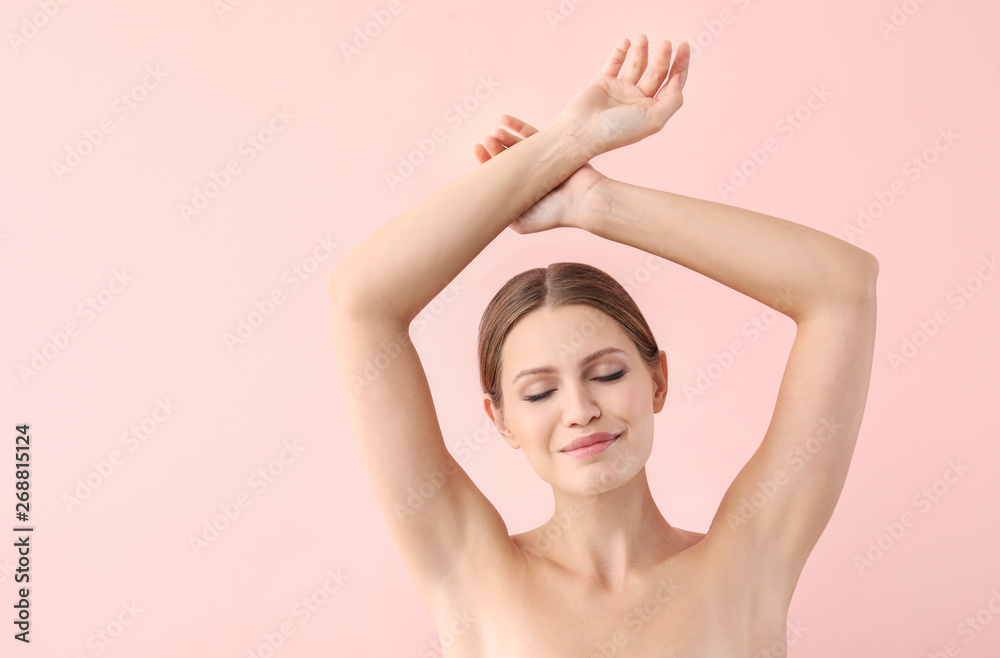 Obraz premium Beautiful young woman after laser hair removal procedure on color background