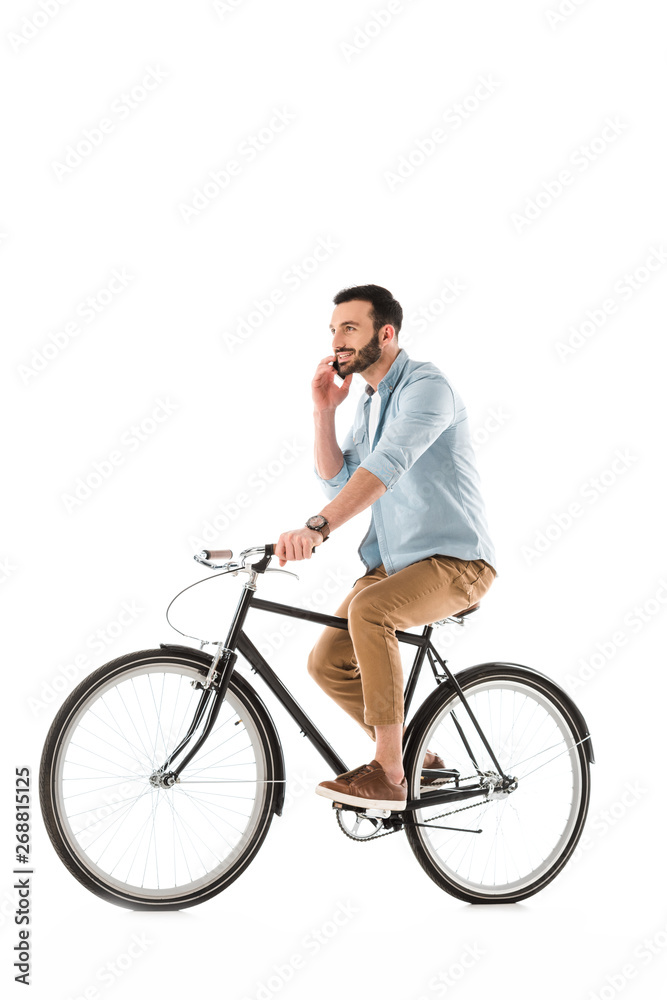 smiling bearded man riding bicycle and talking on smartphone isolated on white smiling bearded man riding bicycle and talking on smartphone isolated on white