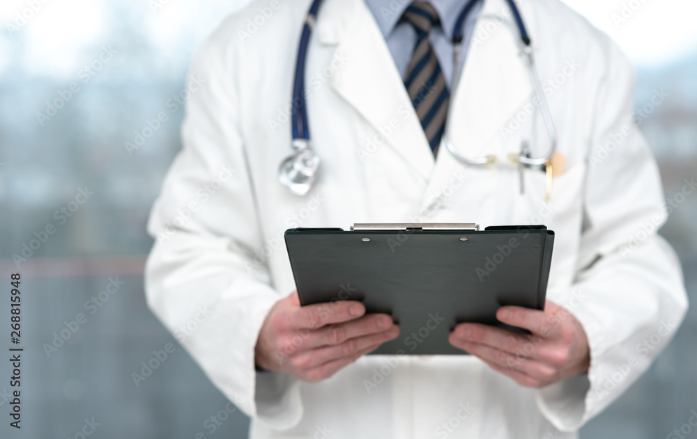 Doctor holding a clipboard Doctor holding a clipboard